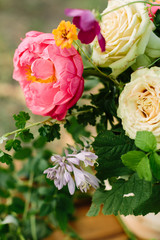 wedding, floral design, arts and crafts, decoration, summer concept - close-up of blooming bright pink peony, creamy english roses and raspberry leaves in beautiful bunch