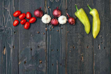 Garlic, onion, paprika and black pepper on wooden rustic table. Copy space. Top view