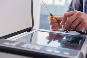 Repairman repairing broken color printer