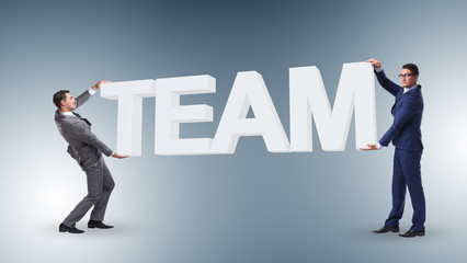 Fototapeta premium Businessmen holding word team in teamwork concept