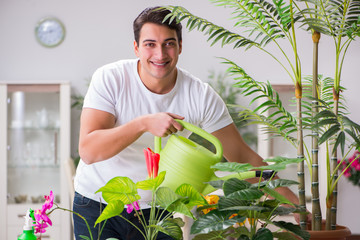 Young man in gardening concept at home