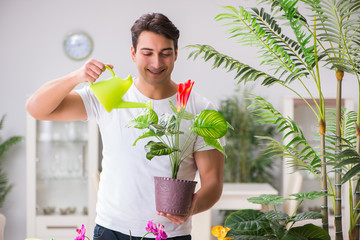 Young man in gardening concept at home