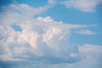 White curly clouds in a blue sky. Sky background