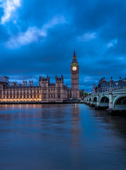 View of the Houses of Parliament and Westminster Bridge in London after dusk