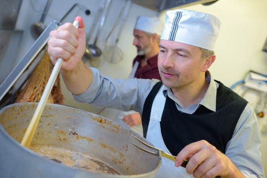 chef stiring at industrial kitchen