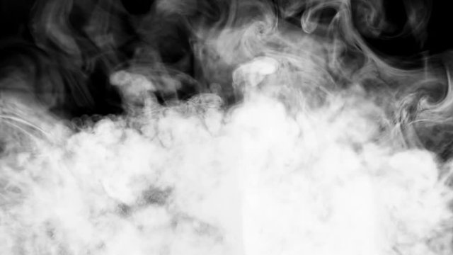 The smoke is spinning against a black background. Slow motion