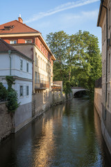 Obraz premium Old buildings, bridge and water canal on the Kampa Island in Prague, Czech Republic.