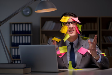 Businessman staying late to sort out priorities