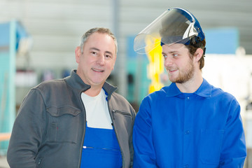 portrait of two workmen one wearing visor