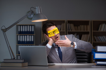 Businessman staying late to sort out priorities