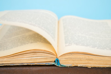 Close up opened vintage book page with blurry text