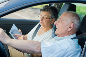 mature couple lost inside of a car