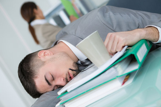 tired business man sleeping on the office desk