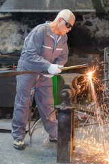old welder perfecting his work