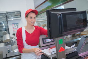 Fototapeta na wymiar pretty butchery woman working in butchery shop