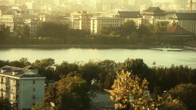 panoramic view of BeiJing BeiHai Park & flock of white pigeons on lake.dusk & dawn.
