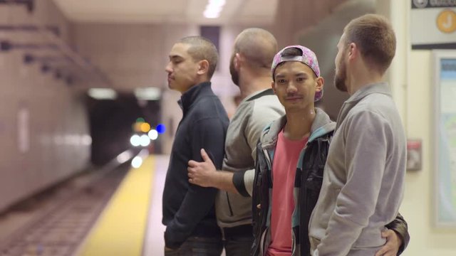 Two Gay Couples Wait On Platform For Subway Train In San Francisco