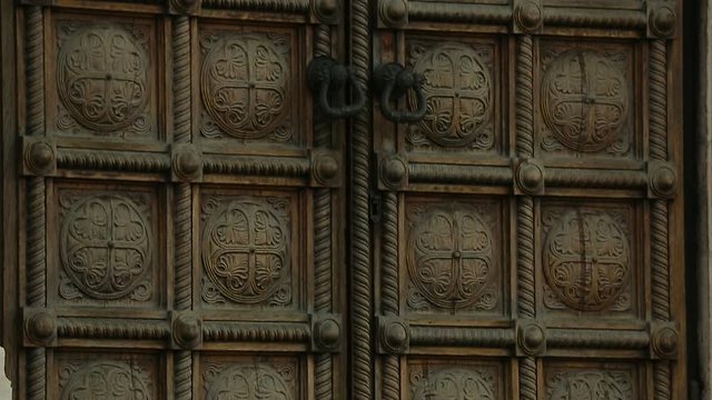 Double ancient doors with carving and massive handles, architecture, entrance