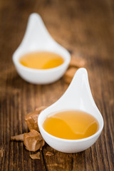 Caramel Syrup on wooden background (selective focus)