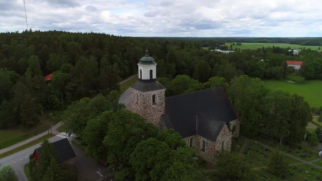 Old medieval stone church, Cinema 4k aerial view around kemio church, on a cloudy summer day, in Kemionsaari, varsinais-suomi, Finland