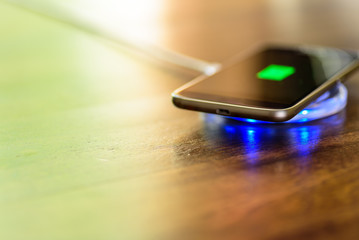 Smartphone charging on a charging pad. Wireless charging