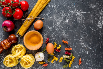 Italian food concept pasta ingredients on grey stone desk background top view copyspace