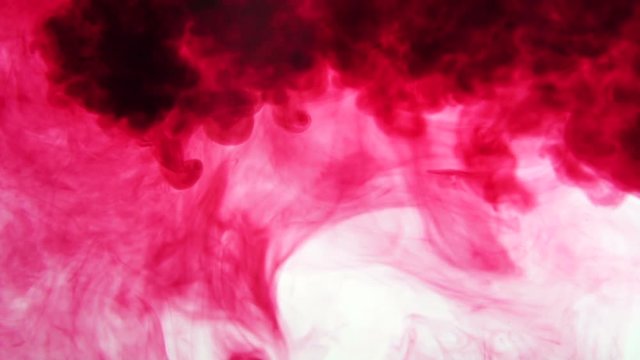Red ink dissolves in water. Slow motion