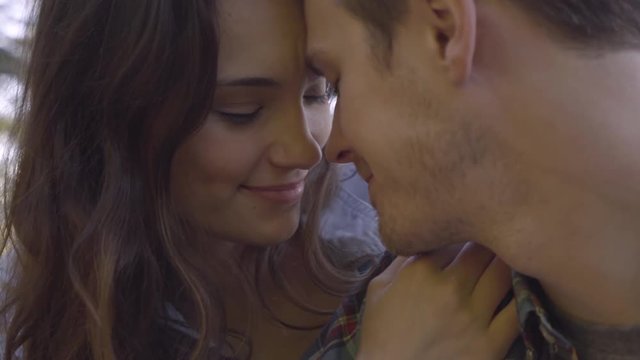 Closeup Portrait Of Young Couple (20s) Kissing In Nature, Backlit