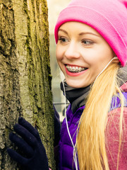 Woman wearing sportswear hugging tree