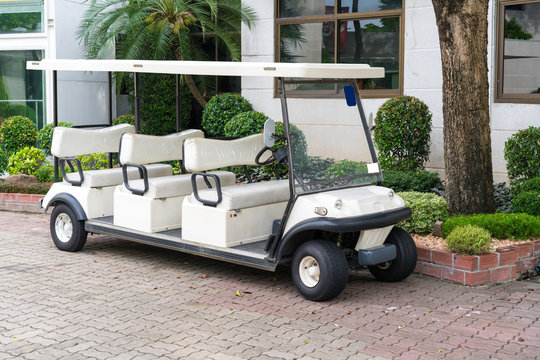 White golf cart with back seats in the public park