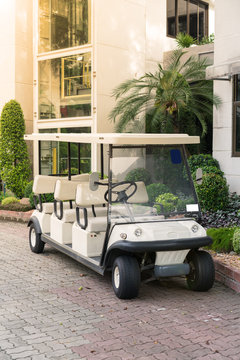 White Golf Cart With Back Seats In The Public Park