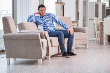 Young man shopping in furniture store