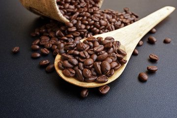 Roasted coffee beans in a wooden spoon