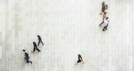 Obraz premium top aerial view of people walk and stand on pedestrian walkway.
