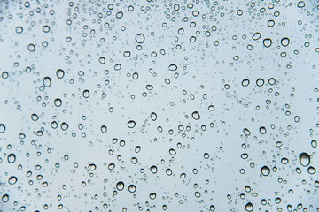 Dew drop on the glass window background.