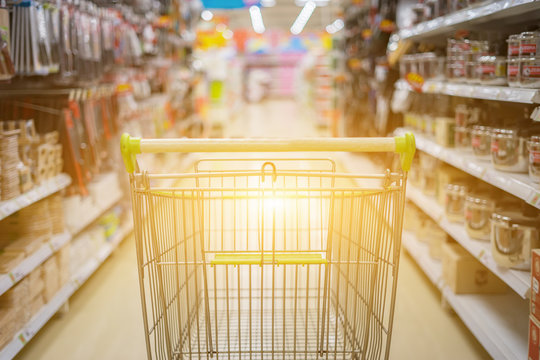 Abstract blurred photo of trolley in department store bokeh background,Shopping cart in supermarket ,vintage color