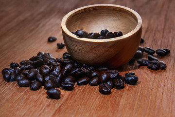 Roasted coffee beans espresso with a wood background