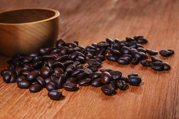 Roasted coffee beans espresso with a wood background