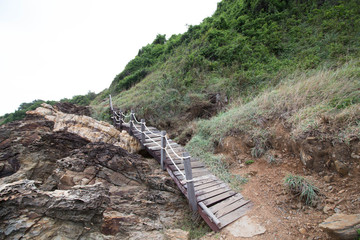 The way is walk to see a sunset with wood bridge .