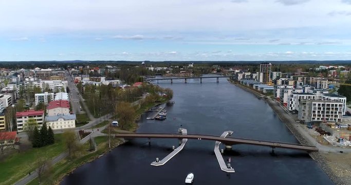 Joensuu, Cinema 4k aerial view above pielisjoki river and between the cityscape, on a spring day, in Karelia, Finland
