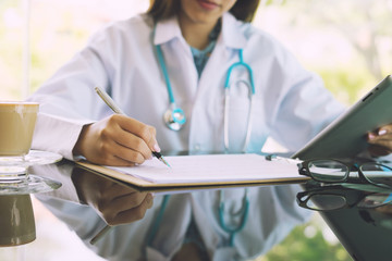 Women Doctors and patient are discussing something ,Having Consultation,Medical Pretty Doctor working in hospital writing a prescription, Healthcare and medically concept,selective focus