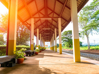 Tranquil scene of train platform in station in rural area with no peolple