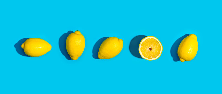 Fresh lemon pattern on a vivid blue background flat lay