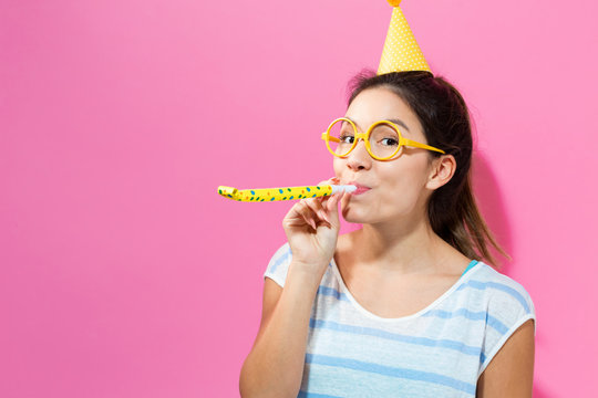 Young Woman With Party Hat With Noisemaker