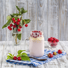 Smoothies from strawberries, raspberries, cherry, oat flakes and ice cream in mason jar mug