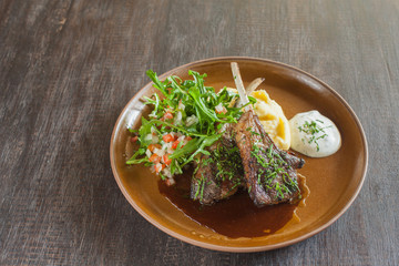 Grilled lamb with mash potato and  arugula salad.