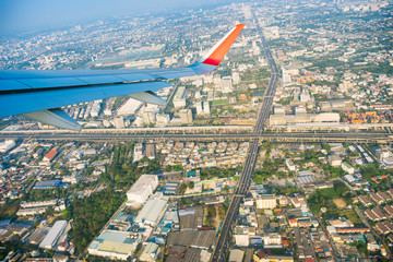 View of plane wing with cityscape