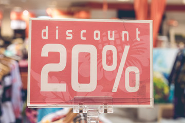 Red sale sign 20 percent discount on blurred background in a shopping mall of Bali, Indonesia, Asia.