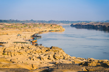 Boat docked in Mekong river near Sam Pan Bok canyon in Ubon Ratchathani , Thailand.