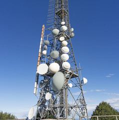 Group of towers for telecommunications on the top of the mountain. Electromagnetic and environmental pollution. Linzone mountain pick. Orobie Prealps. Italy